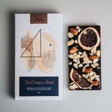 orange and almond chocolate bar and packaging on white background. vegan chocolate bar and packaging